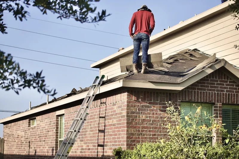 Professional roofer working on a residential roof in Sunland